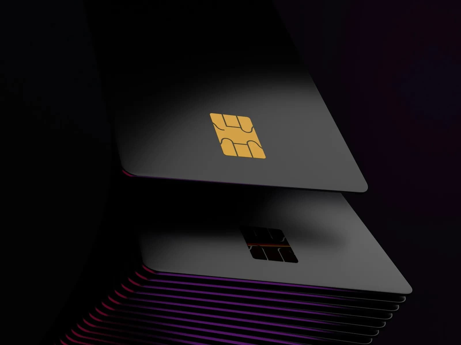 Two blank payment cards with gold chips in low light